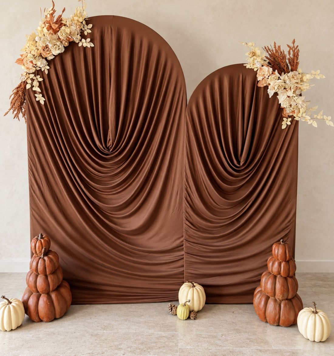 Cinnamon draped arches with pumpkins and dried florals